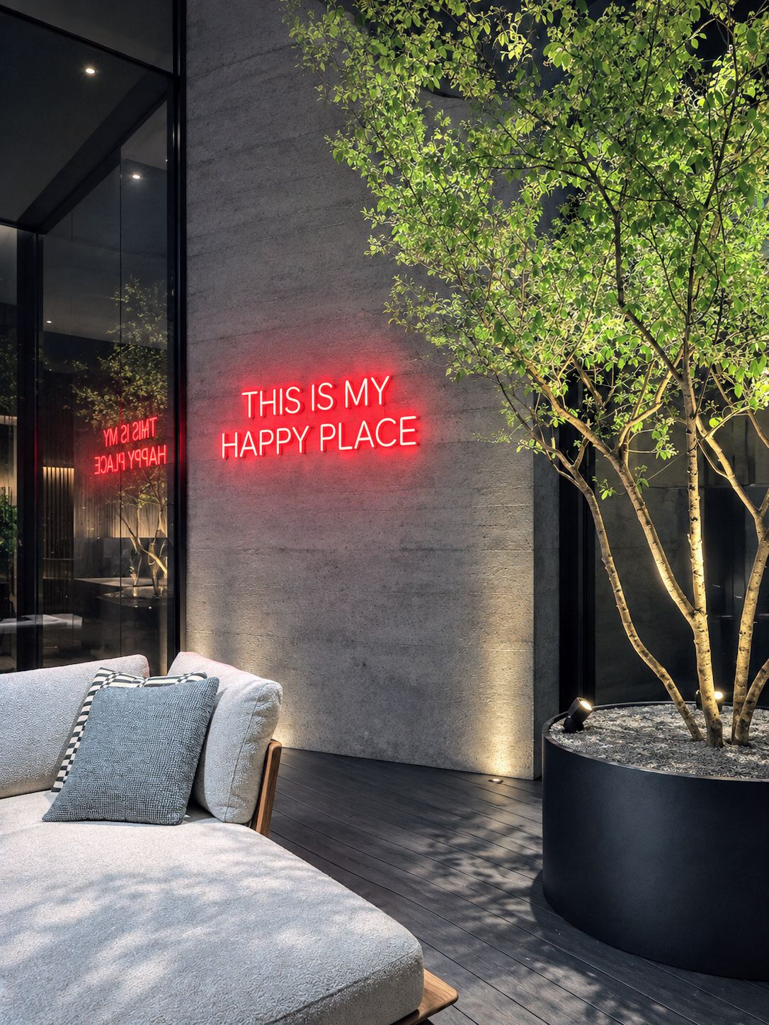 Lounge with a red This is my happy place neon sign, sofa and illuminated tree